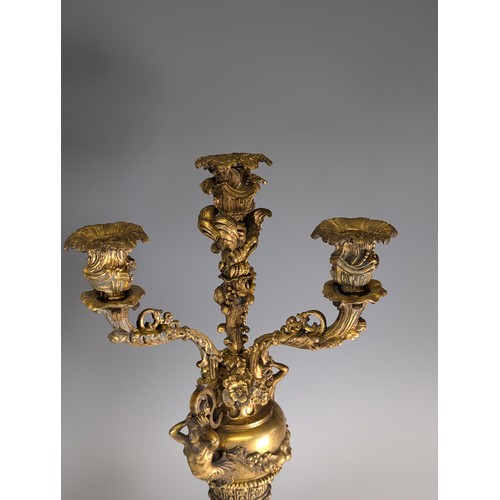 443 - A Pair of gilt metal four-branch Candelabra, in Louis XV style, with leaf-sheathed sockets and scrol... 