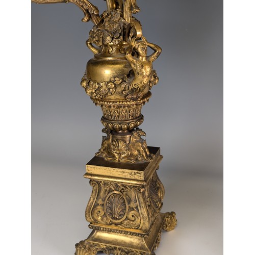 443 - A Pair of gilt metal four-branch Candelabra, in Louis XV style, with leaf-sheathed sockets and scrol... 