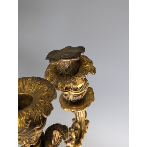 443 - A Pair of gilt metal four-branch Candelabra, in Louis XV style, with leaf-sheathed sockets and scrol... 