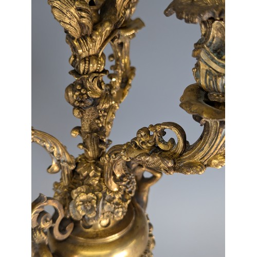 443 - A Pair of gilt metal four-branch Candelabra, in Louis XV style, with leaf-sheathed sockets and scrol... 