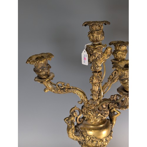 443 - A Pair of gilt metal four-branch Candelabra, in Louis XV style, with leaf-sheathed sockets and scrol... 