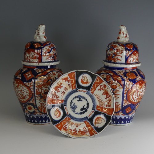 142 - A pair of Japanese imari Temple Jars, decorated in typical style with dog finial to cover, H 34cm, a... 