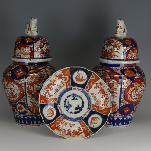 142 - A pair of Japanese imari Temple Jars, decorated in typical style with dog finial to cover, H 34cm, a... 