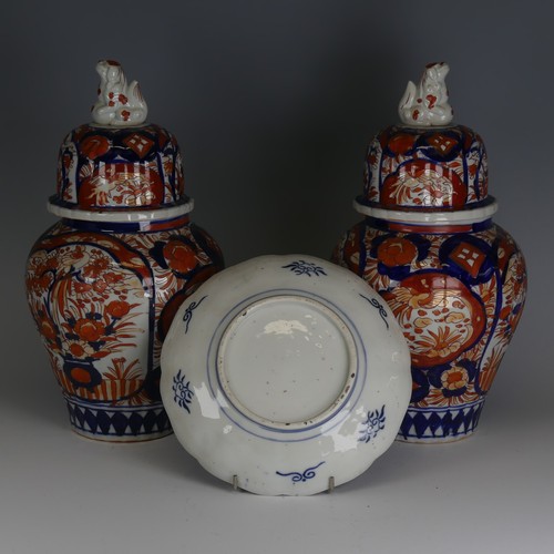 142 - A pair of Japanese imari Temple Jars, decorated in typical style with dog finial to cover, H 34cm, a... 