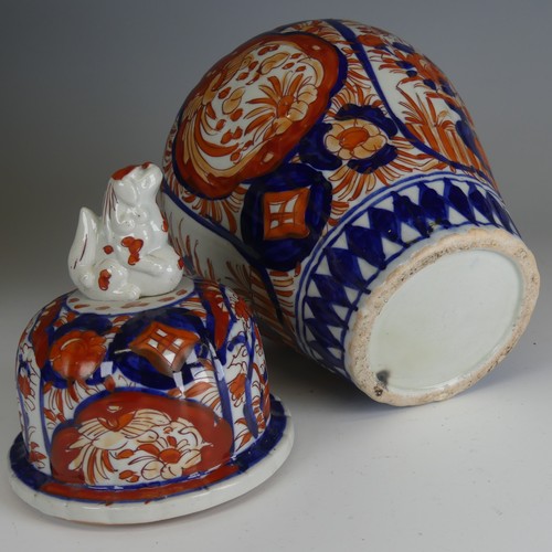 142 - A pair of Japanese imari Temple Jars, decorated in typical style with dog finial to cover, H 34cm, a... 