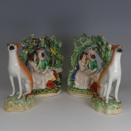 91 - A pair of antique Staffordshire porcelain Greyhounds, decorated in typical colours in seated positio... 