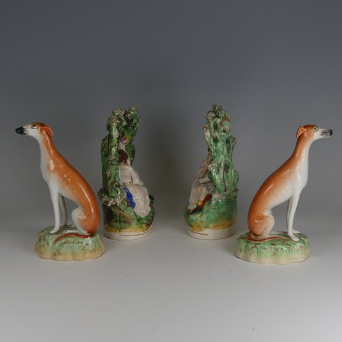 91 - A pair of antique Staffordshire porcelain Greyhounds, decorated in typical colours in seated positio... 