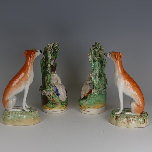 91 - A pair of antique Staffordshire porcelain Greyhounds, decorated in typical colours in seated positio... 