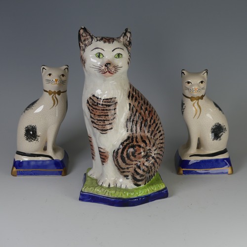 96 - An antique Staffordshire porcelain Figure of a seated Cat, decorated with sponged striped coat, with... 