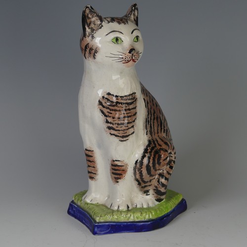 96 - An antique Staffordshire porcelain Figure of a seated Cat, decorated with sponged striped coat, with... 