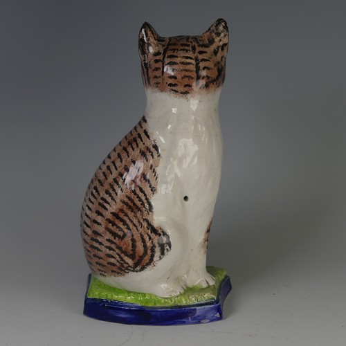 96 - An antique Staffordshire porcelain Figure of a seated Cat, decorated with sponged striped coat, with... 