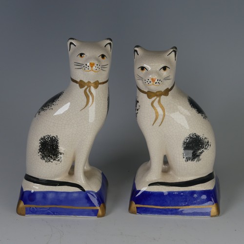 96 - An antique Staffordshire porcelain Figure of a seated Cat, decorated with sponged striped coat, with... 