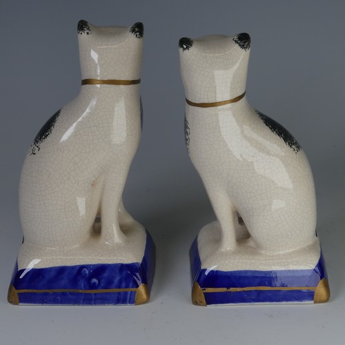 96 - An antique Staffordshire porcelain Figure of a seated Cat, decorated with sponged striped coat, with... 