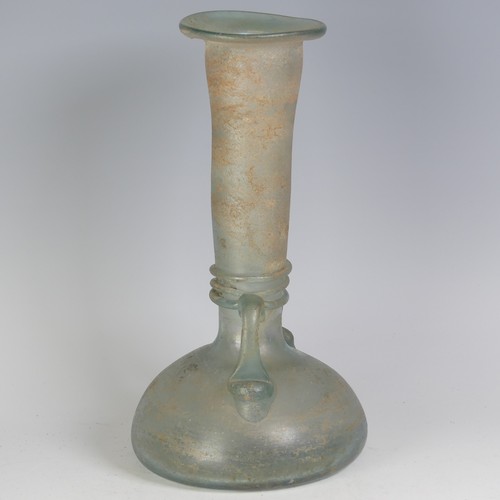 158 - A Roman green glass Vase, with pinched waist and bulbous flat base, flanked with twin-handles, with ... 