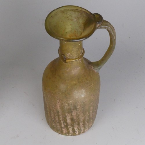 162 - A Roman glass fluted Flask, in green colour, with loop handle with ribbon trail to neck, H 10.8cm, t... 