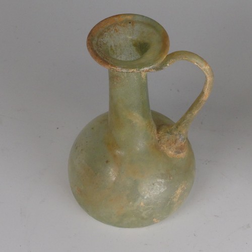 162 - A Roman glass fluted Flask, in green colour, with loop handle with ribbon trail to neck, H 10.8cm, t... 