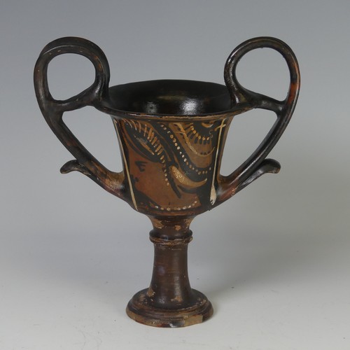 169 - An Apulian pottery red figure Kantharos, raised on a knopped stem with a bell shaped body, each side... 