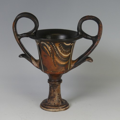 169 - An Apulian pottery red figure Kantharos, raised on a knopped stem with a bell shaped body, each side... 