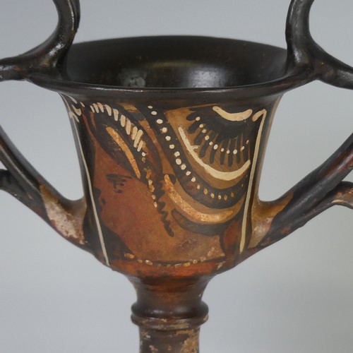 169 - An Apulian pottery red figure Kantharos, raised on a knopped stem with a bell shaped body, each side... 