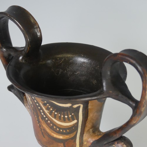 169 - An Apulian pottery red figure Kantharos, raised on a knopped stem with a bell shaped body, each side... 