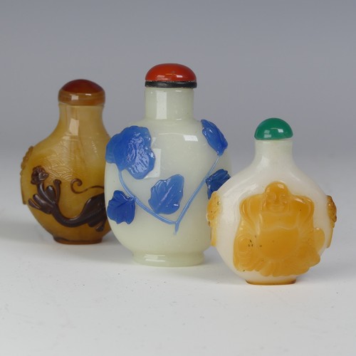 149 - A Chinese Peking blue-overlay glass Snuff Bottle, 20th century, carved with blooming lotus flowers i... 