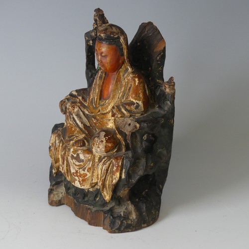 150 - An antique Chinese polychrome and gilt-lacquered wood figure of Guanyin, possibly Qing dynasty, seat... 