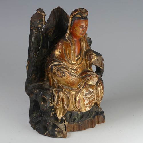 150 - An antique Chinese polychrome and gilt-lacquered wood figure of Guanyin, possibly Qing dynasty, seat... 