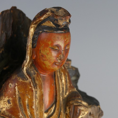 150 - An antique Chinese polychrome and gilt-lacquered wood figure of Guanyin, possibly Qing dynasty, seat... 