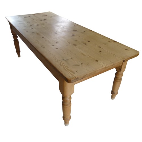 459 - A 20th century pine farmhouse kitchen Table, rounded rectangular top raised on turned supports, W 21... 