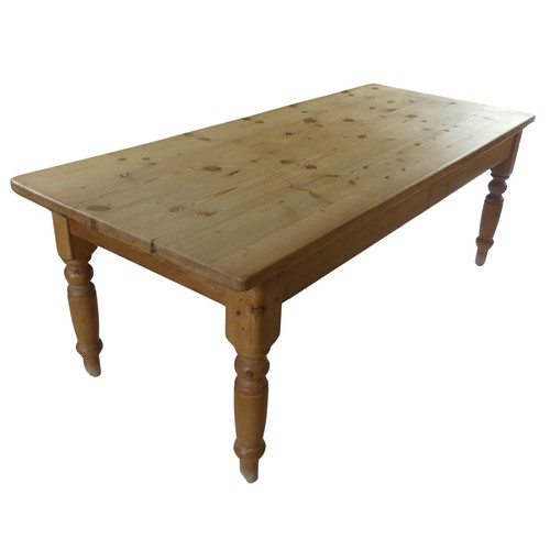 459 - A 20th century pine farmhouse kitchen Table, rounded rectangular top raised on turned supports, W 21... 