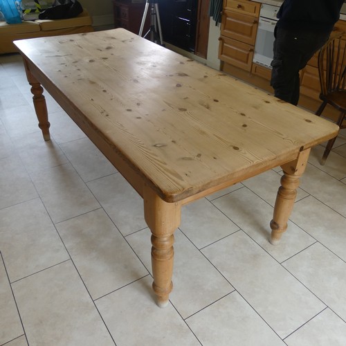 459 - A 20th century pine farmhouse kitchen Table, rounded rectangular top raised on turned supports, W 21... 