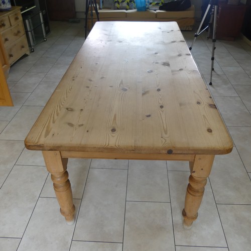 459 - A 20th century pine farmhouse kitchen Table, rounded rectangular top raised on turned supports, W 21... 