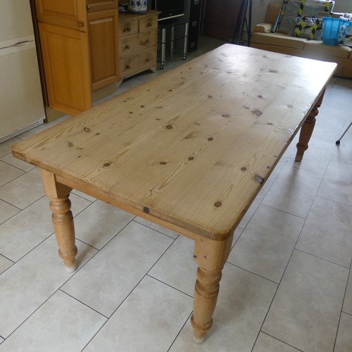 459 - A 20th century pine farmhouse kitchen Table, rounded rectangular top raised on turned supports, W 21... 