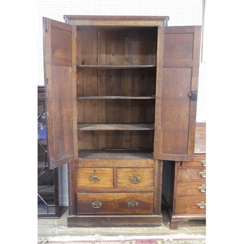 461 - A large 20th century oak panelled Cupboard, moulded cornice over two large panelled doors, concealin... 