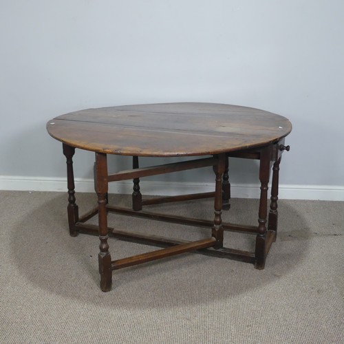 464 - An 18th century oak gateleg Table, with deep drawers to either end and raised on turned supports, W ... 