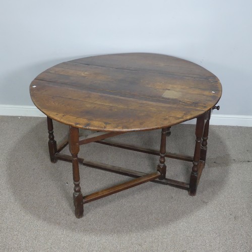 464 - An 18th century oak gateleg Table, with deep drawers to either end and raised on turned supports, W ... 