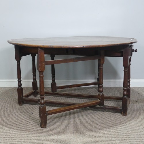 464 - An 18th century oak gateleg Table, with deep drawers to either end and raised on turned supports, W ... 