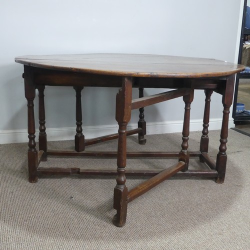 464 - An 18th century oak gateleg Table, with deep drawers to either end and raised on turned supports, W ... 