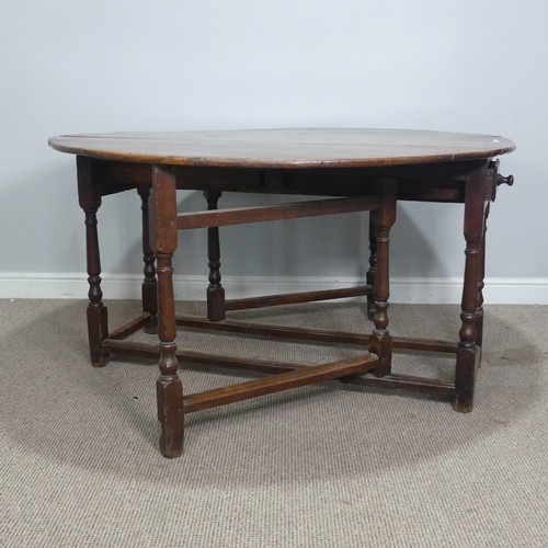 464 - An 18th century oak gateleg Table, with deep drawers to either end and raised on turned supports, W ... 