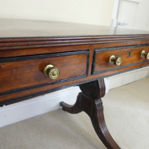 466 - A William IV mahogany and rosewood Library Table, the rectangular rounded top with rosewood banding,... 