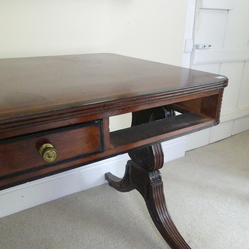 466 - A William IV mahogany and rosewood Library Table, the rectangular rounded top with rosewood banding,... 