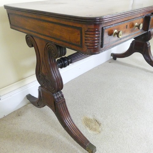 466 - A William IV mahogany and rosewood Library Table, the rectangular rounded top with rosewood banding,... 