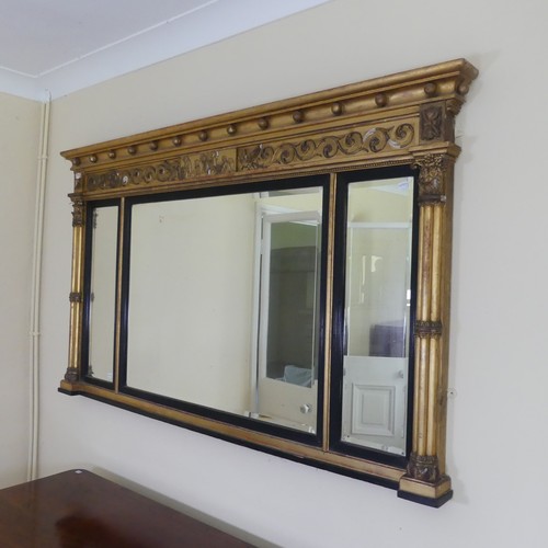 467 - A Regency carved giltwood and ebonised triptych overmantle Mirror, the moulded cornice with applied ... 