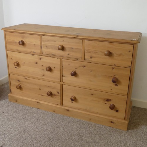 472 - A contemporary pine Chest of drawers, three short drawers over four long drawers, raised on plinth b... 