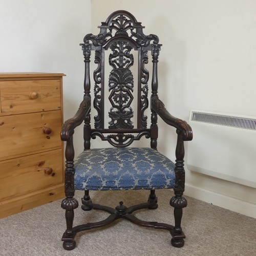 473 - A Victorian Carolean style Armchair, heavily carved and pierced backrest decorated with shells and s... 