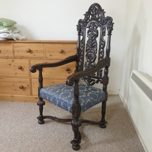 473 - A Victorian Carolean style Armchair, heavily carved and pierced backrest decorated with shells and s... 