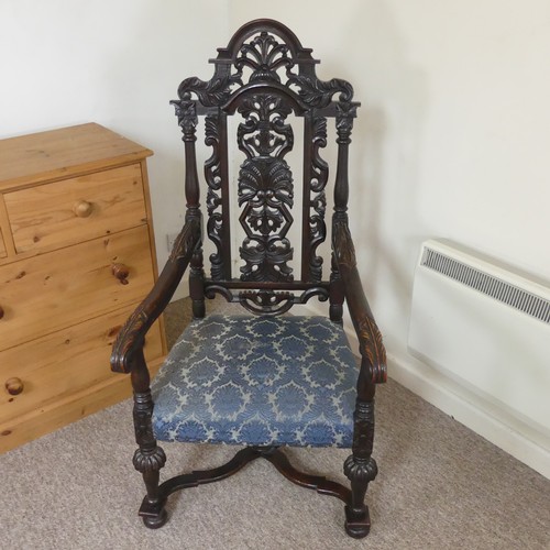 473 - A Victorian Carolean style Armchair, heavily carved and pierced backrest decorated with shells and s... 