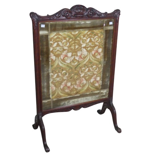 480 - A Victorian carved mahogany framed fire Screen, raised on splayed legs, W 64 cm x H 94 cm x D 36 cm.... 