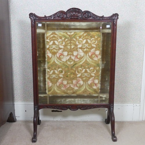 480 - A Victorian carved mahogany framed fire Screen, raised on splayed legs, W 64 cm x H 94 cm x D 36 cm.... 