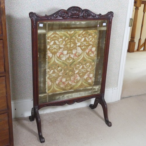 480 - A Victorian carved mahogany framed fire Screen, raised on splayed legs, W 64 cm x H 94 cm x D 36 cm.... 